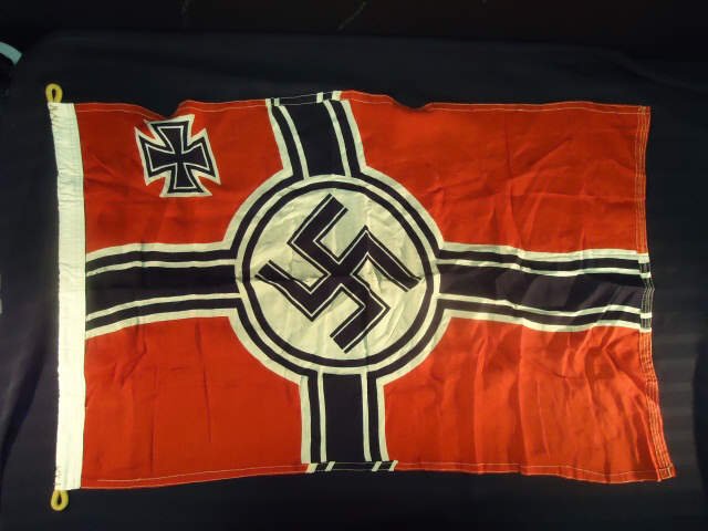 German World WarII Military Kreigs War Battle Flag: German World War II Military Kreigs War Battle Flag. Measures 22 1/4 by 35 1/2". Printed cotton construction. Has the swastika in the center with an Iron Cross in the corner"