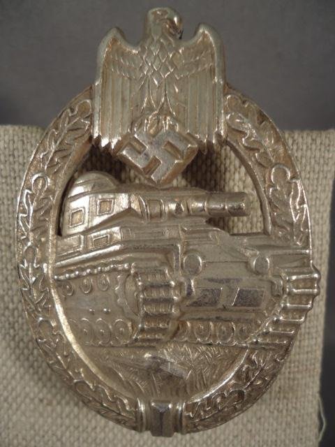 German World War II Army Silver Tank Assault Badge: German World War II Army Silver Tank Assault Badge. Has a thin vertical pin back. Maker marked 'HA' for the firm of Hermann Aurich Dresden