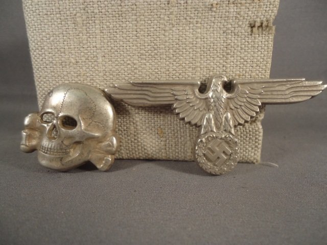 WWII Waffen SS Officers Visor Cap Eagle/Skull Set: German World War II Waffen SS Officers Visor Cap Eagle & Skull. Both are maker marked 'RZM M1/24'. They have two flat prongs on the reverse. Stamped silver plated brass construction