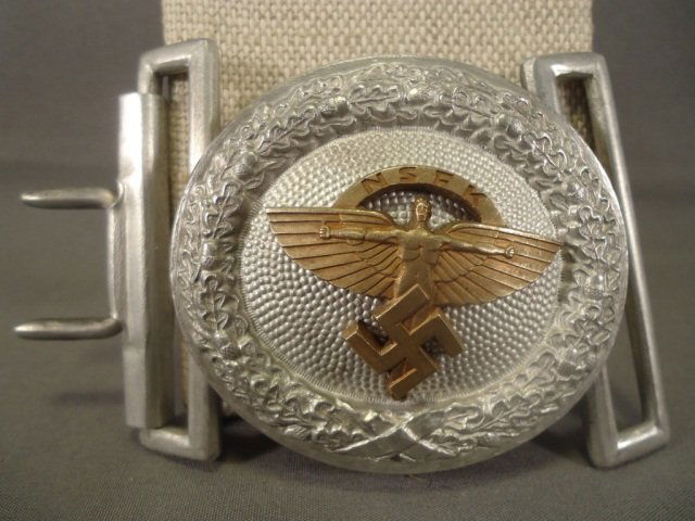 German WWII NSFK Glider Korps Officers Belt Buckle: German World War II NSFK Glider Korps Officers Belt Buckle. Maker marked 'A'. Measures 2" by 2 1/8". Includes both keepers. Aluminum and brass construction.