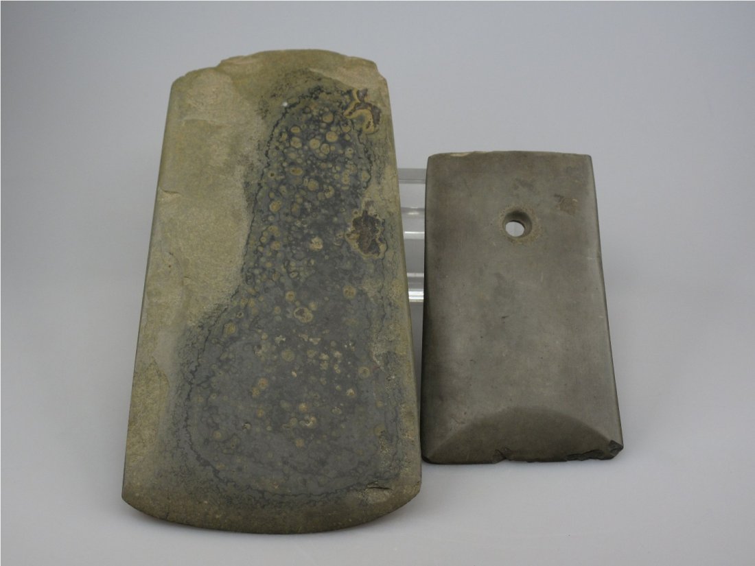 Two Chinese Stone Axes, Yue, Neolithic Period: One in pristine condition with veins, another pierced with a circular perforation. L: 26 cm & L: 16 cm