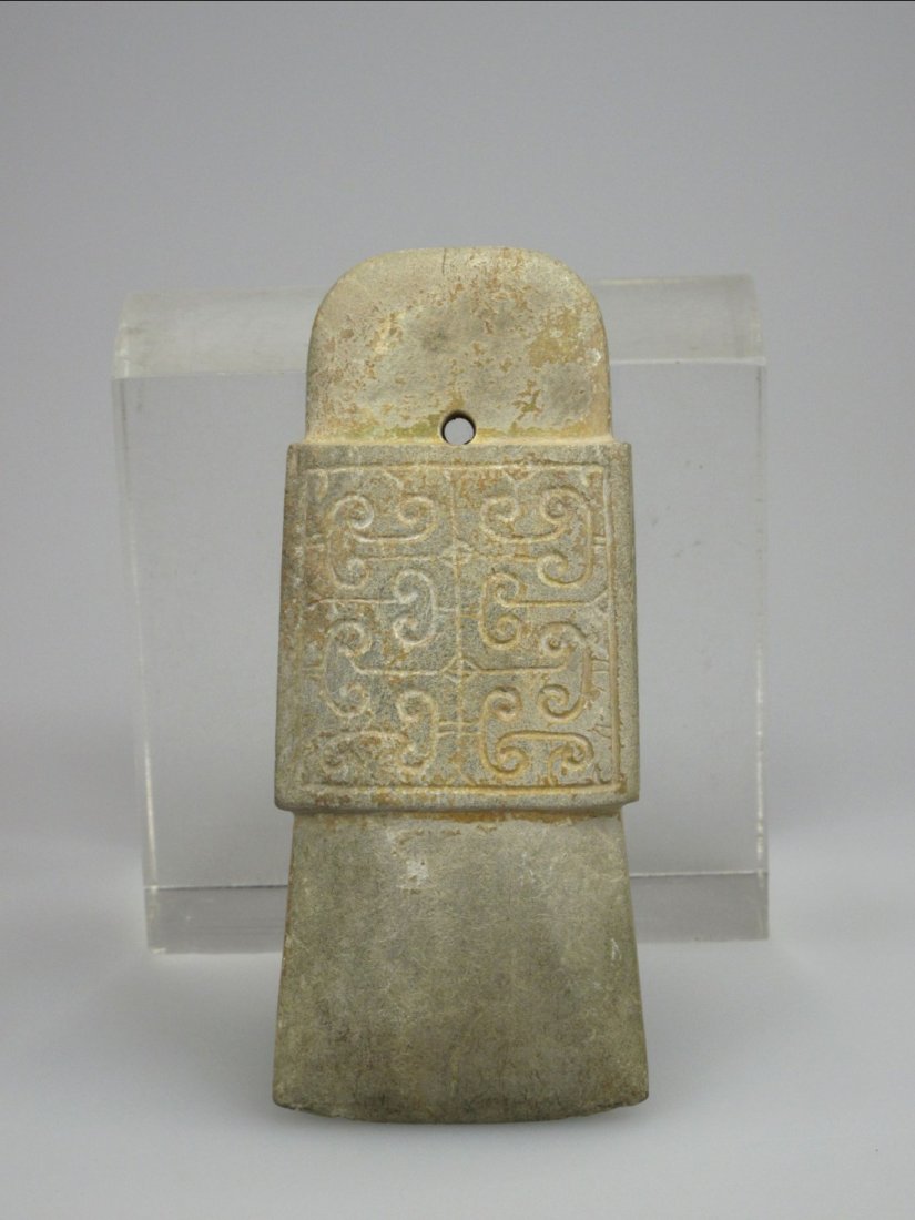 Chinese Jade Axe with Cloud Pattern, Shang Dynasty: A Chinese Jade Axe with Cloud Pattern, Shang Dynasty. Smoothly and formed of arc-shaped at the top with a perforation. H: 13.7cm W: 5.5cm