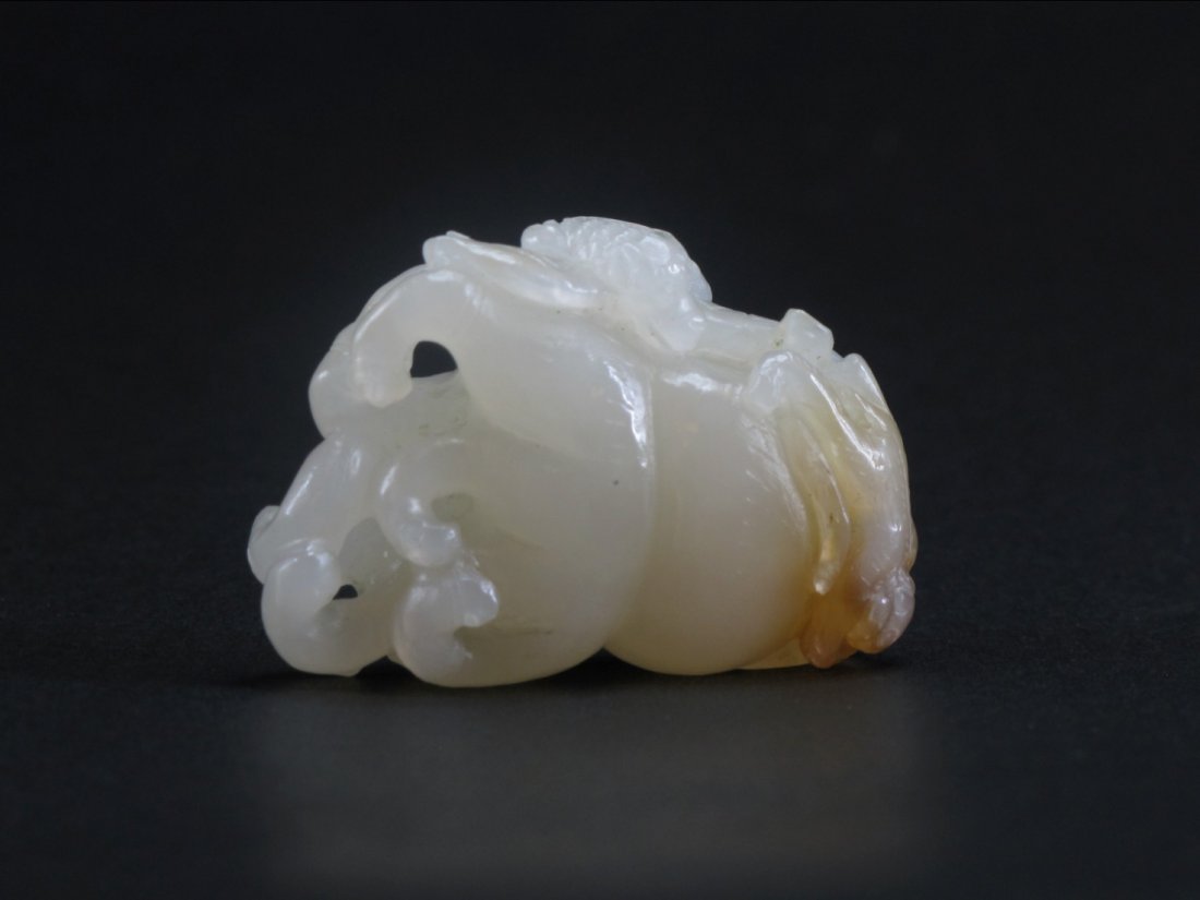 A Chinese White Jade “Buddha Hand” Pendant, Qing: A Chinese White Jade “Buddha Hand” Pendant, Qing Dynasty. Citron form, the side of the fruit clamber two small monkeys. L: 4.8 cm