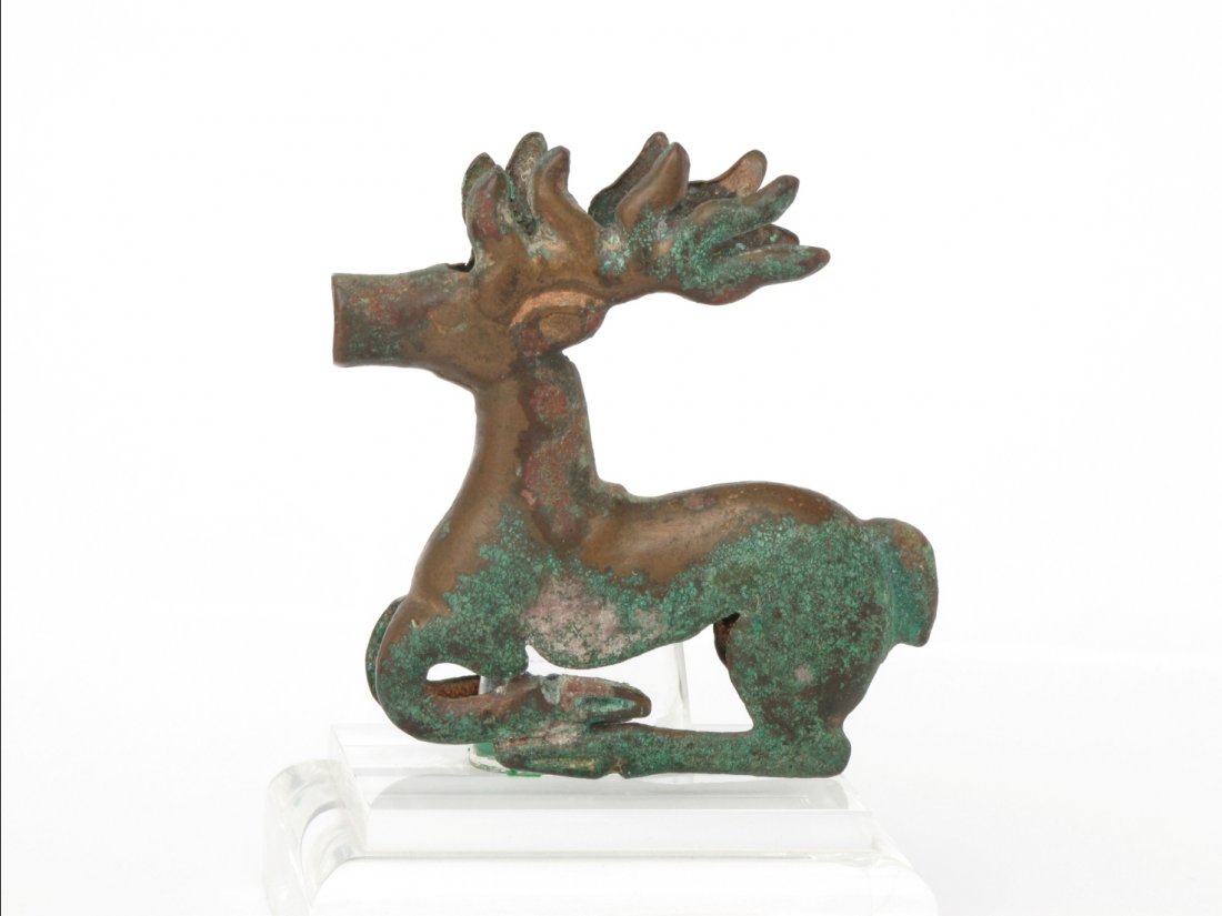 Chinese Ordos Bronze Ornament, Warring States: A Chinese Ordos Bronze Resting Deer Shrine Ornament, Warring States. The legs folded beneath the body. H: 8.2 cm