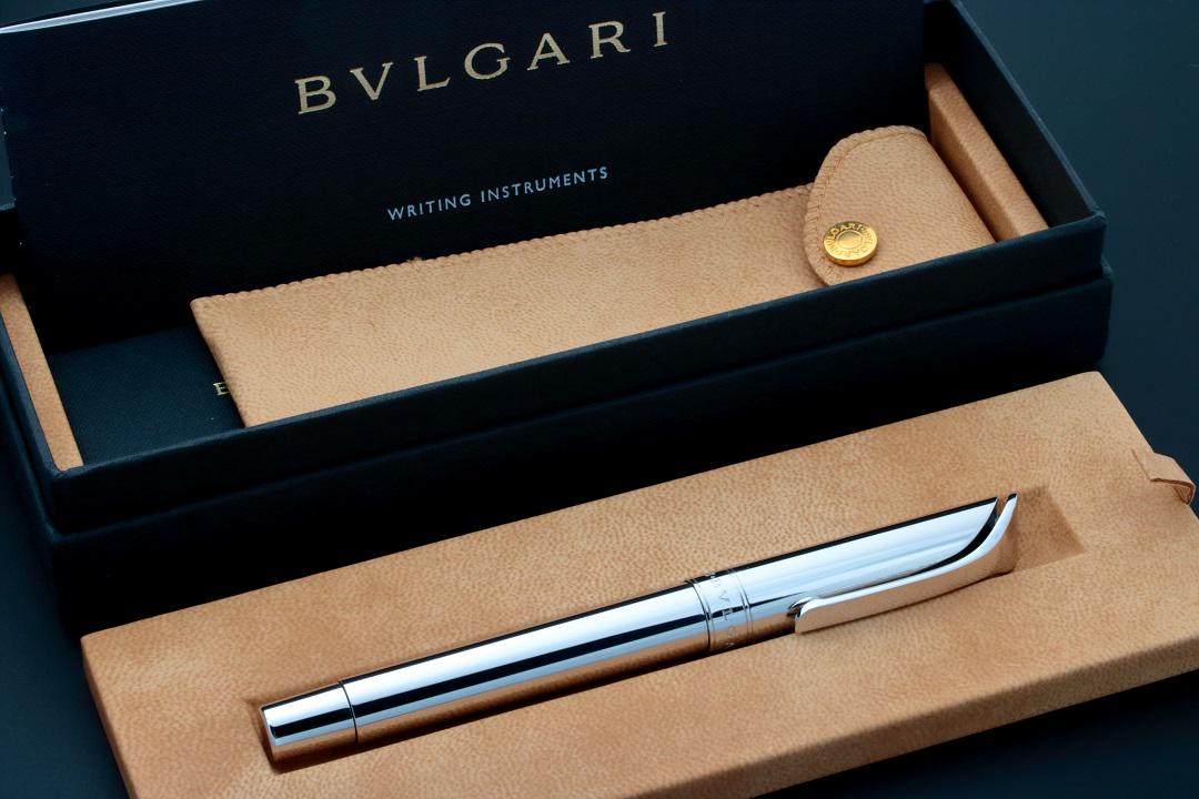 Bvlgari Rollerball Sterling Silver Pen: Sterling silver Bvlgari rollerball pen. Made in Italy. Stamped 925 under the clip indicating sterling silver. Black ink. Accompanied by a fitted Bvlgari pen box, Bulgari leather pen pouch, and