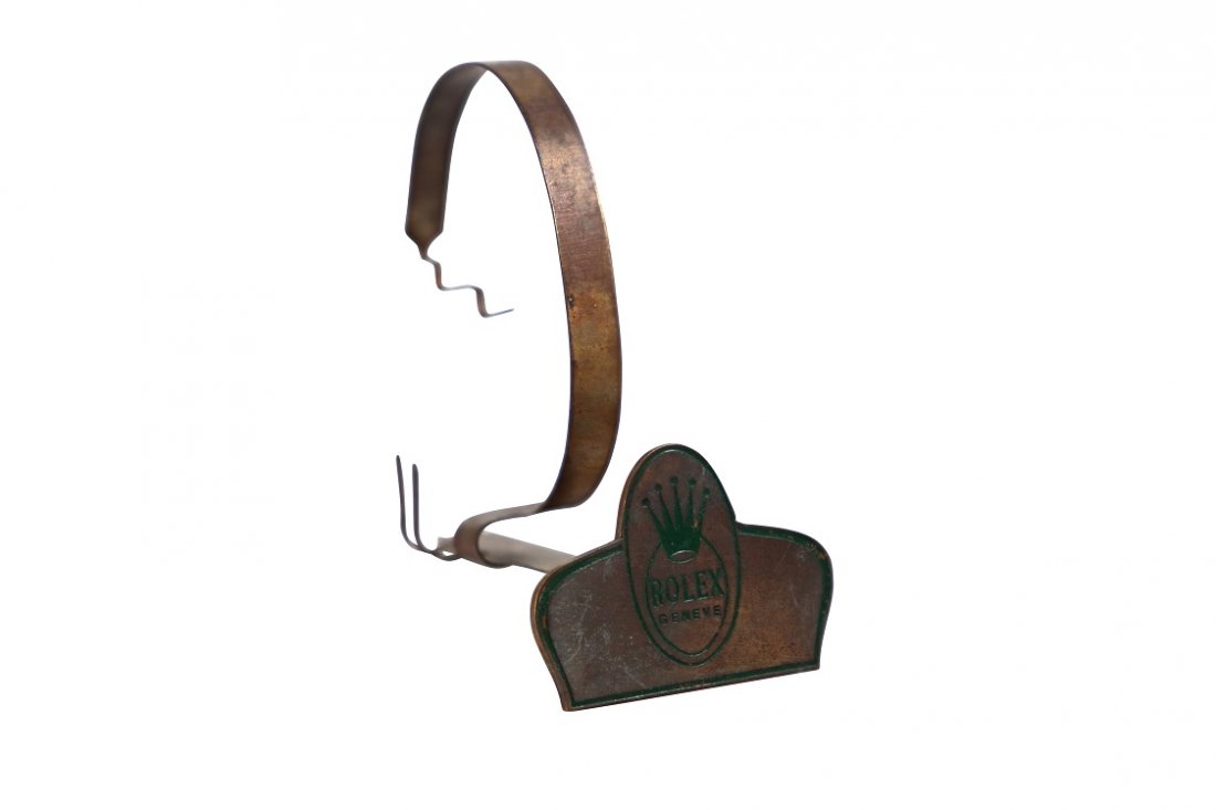 Rolex Geneve Watch Dealer Display Stand Vintage: Rare vintage Rolex dealer watch cuff stand. Metal watch stand with green enamel Rolex Geneve with Rolex Coronet. Bottom of the base is stamped Swiss Made with a number. Rare watch collector’s displa