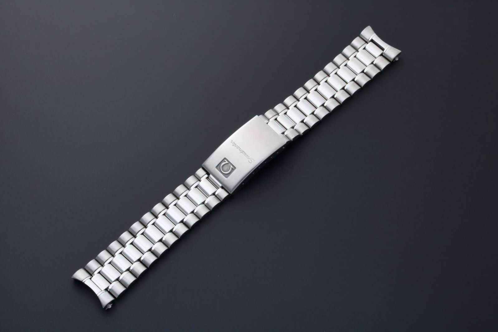 Omega Speedmaster 18MM Watch Bracelet 1469/811: Stainless steel 18mm Omega Speedmaster watch bracelet. Swiss made. Buckle stamped Omega 1469 with matching end pieces stamped 811. Comes as shown without spring bars. Shown at full stretch. 
