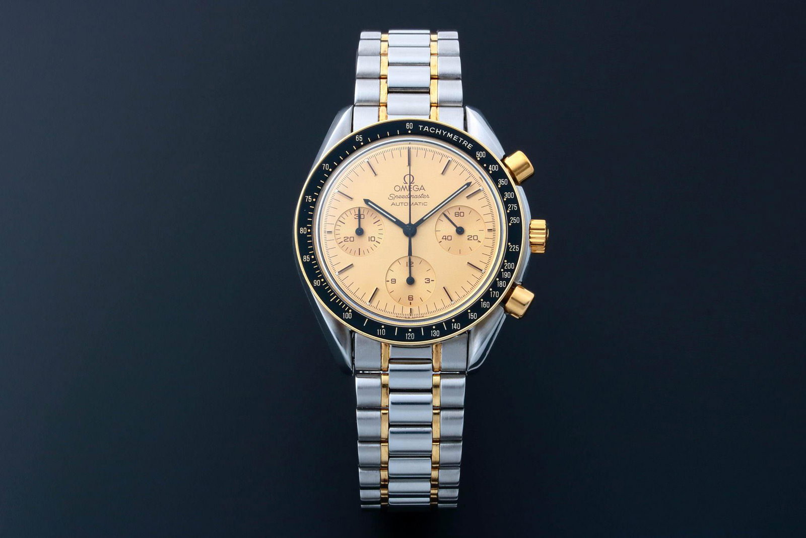 Omega Speedmaster Watch 3310.10.00 Tutone: Gents stainless steel and yellow gold Omega Speedmaster chronograph wristwatch, ref #3310.10. Champagne Omega dial with applied bar hour markers. Tachymetre bezel. Omega hesalite crystal. Swis