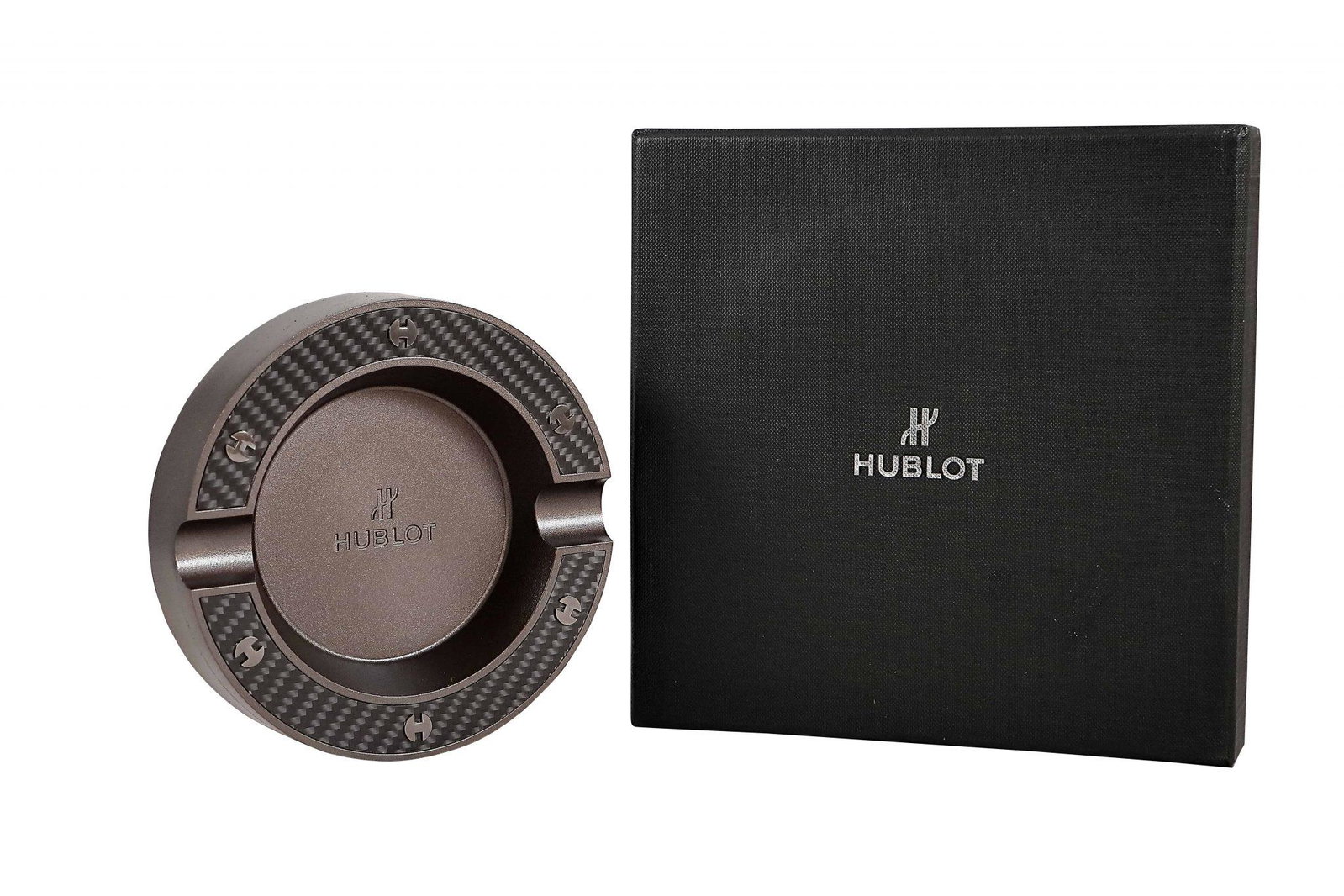 Rare Hublot Fusion Ashtray with Box: Hublot promotional ashtray with carbon fiber accents. The top edge of the ashtray resembles a carbon fiber bezel on a Hublot watch. The side is engraved "The Art of Fusion." Accompanied by a fi