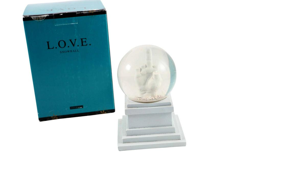 Maurizio Cattelan L.O.V.E. Snowball Snow Globe: Artist: Maurizio Cattelan Title: L.O.V.E. Snowball Snow Globe - LOVE is an acronym for Libertá (freedom), Odio (hate), Vendetta (revenge), and Eternitá (eternity). Medium: Glass, resin. glitter, and