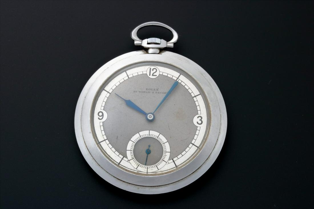 Vintage Rolex Open Face Pocket Watch Deco Style Dial: Vintage stainless steel open face Rolex pocket watch. Two tone gray and silver Rolex Deco style dial with painted Arabic numerals and sub seconds. Blue steel hands. Step bezel. Keyless mechani