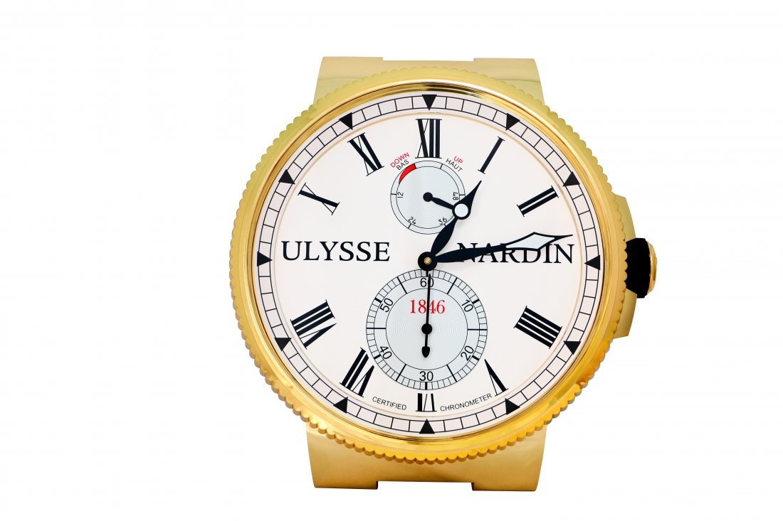 Ulysse Nardin Marine Wall Clock Gold Tone: Large Ulysse Nardin gold toned dealer wall clock, resembling the UN Marine wristwatch. White dial with black Roman hour markers. Gold toned case with gold toned coin edged bezel. Has two quartz