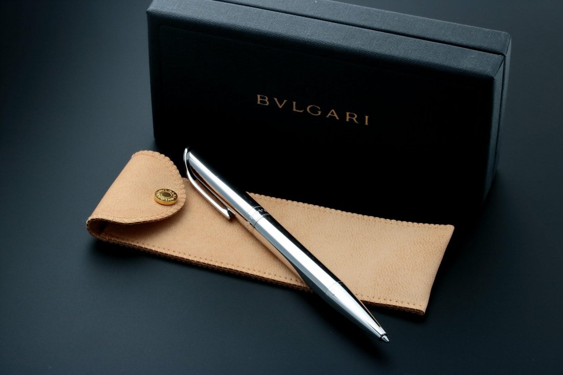 Sterling Silver Bvlgari Pen with Leather Pouch: Sterling silver Bvlgari pen. Made in Italy. Stamped 925 under the clip indicating sterling silver. Accompanied by a fitted Bvlgari pen box. Approximate dimensions of the pen are 140mm x 11mm.Fine hair