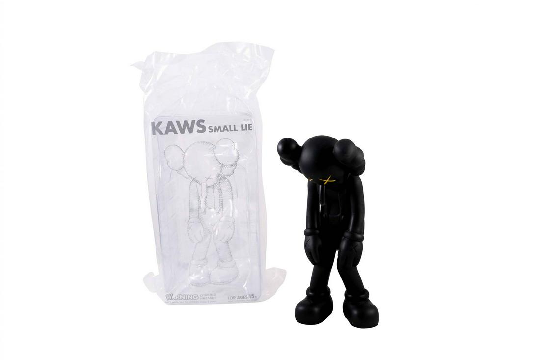 KAWS Small Lie Black Vinyl Figure Sculpture Open: Artist: KAWS Title: Small Lie Black Medium: Vinyl Approximate Dimensions: 11in Edition: 2017 Provenance: Private collection Condition Report: Opened. Includes original KAWS p