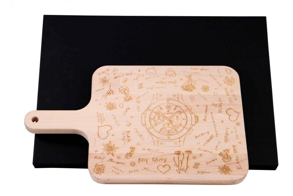 Hublot Big Bang Chronograph Wood Cutting Board Display: Brand: Hublot Description: Wood cutting board featuring a Hublot Big Bang Chronograph watch in the center. Promotional gift for VIP Hublot boutique clients. Condition: Accompanied by a fitt
