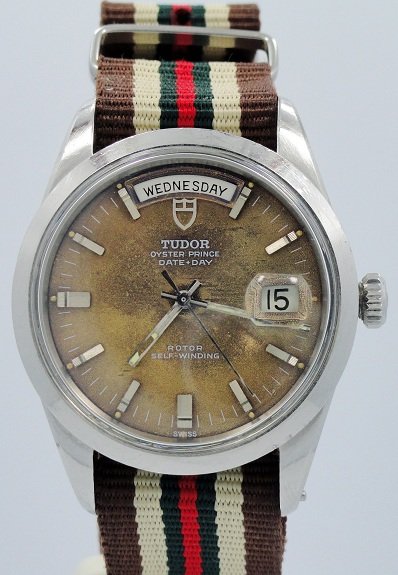 Rolex Tudor Day Date Oyster Prince Watch With Tropi: Rolex Tudor Oyster Prince Day-Date in stainless steel on a canvas military regimental NATO strap. Case, movement, and dial signed Rolex Tudor. This unusual watch has a very rare dial color which shows