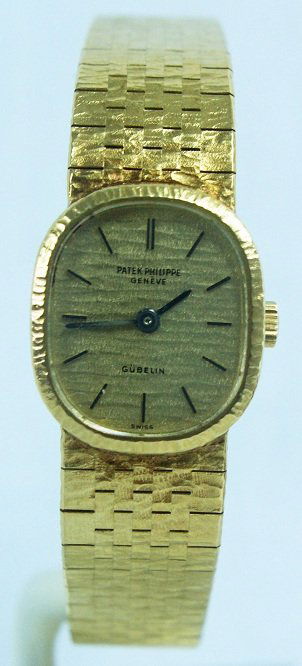 18k Yellow Gold Ladies Patek Philippe Watch Gueblin: Ladies 18k yellow gold Patek Philippe wristwatch, retailed by Gueblin, with signed mechanical movement, signed case, signed dial accompanied by a fitted Gubelin watch case.