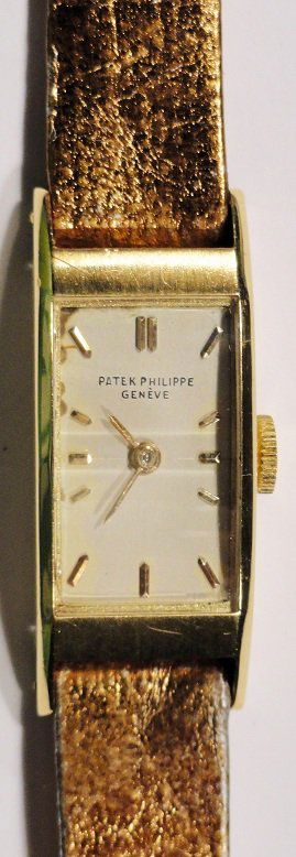 18K Yellow Gold Patek Philippe Ladies Watch: Vintage 18k yellow gold ladies Patek Philippe curved rectangular wristwatch with a two facet crystal.