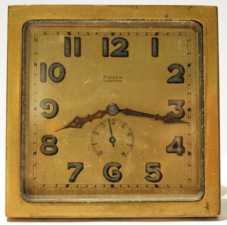 8 day Power Reserve Cartier Travel Desk Clock: Brass 8 day power reserve Cartier travel desk clock. The approximate dimensions are 75.3 mm by 75.3 mm.