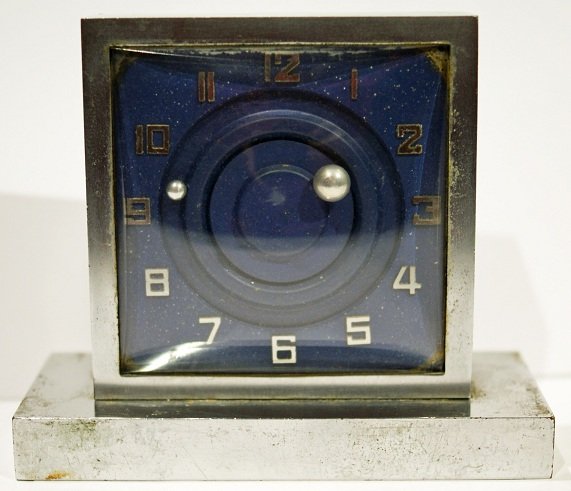 French Art Deco Mystery Clock: French Art Deco mystery table clock. The approximate clock dimensions are 3 inches x 3 inches and 3-1/2 inches x 4 inches including the base.