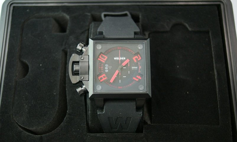 Ion Plated Steel Welder K25 Red Chronograph Watch: Ion plated steel 316L Welder K25 wrist watch with red indexes. Left handed chronograph, water resistant up to 50m design by the U-BOAT founder. Miyota OS10 movement. It comes with Welder carrying case