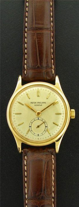 18k Yellow Gold Patek Philippe Waterproof Watch: 18k yellow gold Patek Philippe Calatrava reference 2451 with waterproof case. The 18k yellow gold case diameter is approximately 33 mm with the crown. Manual wind movement. The Patek Philippe cream di