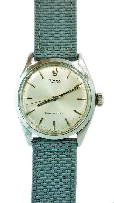 Vintage Rolex Oyster Watch Shock-Resisting Ref #648: Vintage stainless steel men`s Rolex Oyster wristwatch on NATO band, ref #6480, circa 1955. Silver dial with bar hour markers. The dial says "Shock Resisting". Case diameter is approximately 37mm with