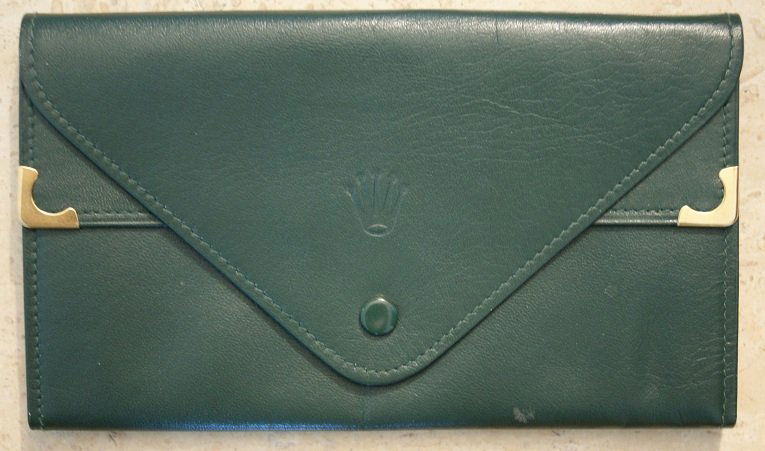 Green Leather Rolex Wallet With Watch Slot: Green leather Rolex wallet with watch slot. The approximate dimensions are 7 - 1/2 x 4 - 1/4 inches.