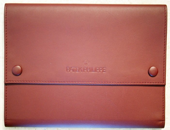 Leather Patek Philippe Travel Wallet 12 Strap Slots: Leather Patek Philippe travel wallet with 12 slots for strap watches or straps. The original Patek Philippe burgundy leather wallet is embossed with the Calatrava symbol and Patek Philippe. Has two sn