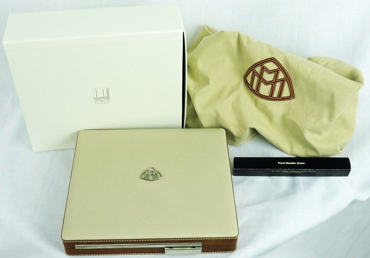 Maybach Travel Cigar Humidor by Dunhill: Very rare Maybach travel cigar humidor by Dunhill Motorities for Maybach with a Maybach credo. The humidor is made of fine leather and wood with the Mayback emblem on the outside of the lid. It comes