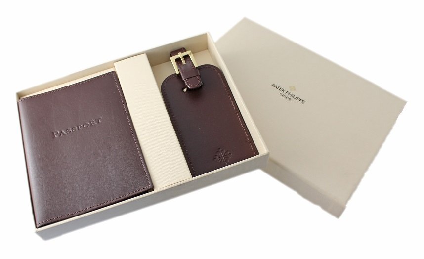 Patek Philippe Luggage Tag and Passport Holder Travel: Patek Philippe leather passport holder and luggage tag set. Accompanied with fitted Patek Philippe box. The passport wallet has the Patek Philippe Calatrava symbol on the inside and the back. The lugg