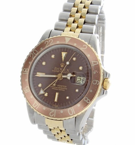 Stainless Steel and Gold Mens Rolex GMT Master Watch: Vintage gents stainless steel and yellow gold Rolex GMT Master wristwatch. Swiss made, automatic movement. Brown Rolex "T Swiss T" nipple dial, brown insert. Comes on a stainless steel and yellow gold