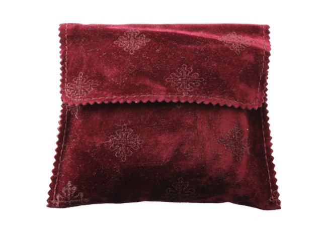 Velvet Patek Philippe Calatrava Travel Pouch with: Unusual Patek Philippe velvet travel pouch with cushion. The exterior and cushion have the Patek Philippe calatrava symbol stamped. In good condition.