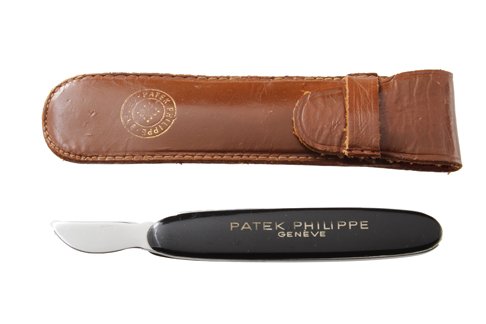 Patek Philippe Watch Opener Knife with Leather Pouch: Patek Philippe watch opener knife with leather pouch. In used condition. Patek Philippe pouch could use some attention.