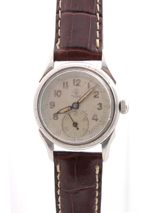Rare Vintage Tudor Swiss Made Screwback Case Watch: Rare vintage Tudor Swiss made waterproof case watch. Swiss made mechanical manual wind Tudor caliber 59 movement. The Swiss made Tudor silver dial with arabic numerals and twenty four hours outer trac