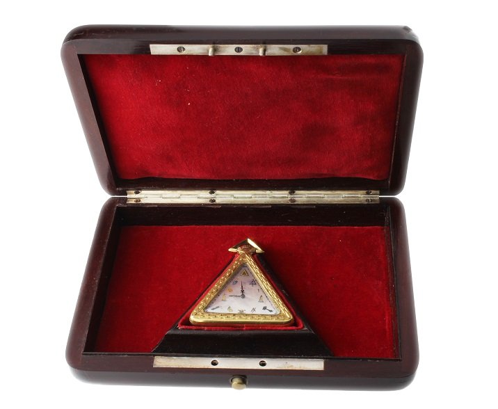 Vintage Masonic Schwab & Brandt Triangular Pocket Watch: Vintage triangular keyless yellow gold filled Masonic pocketwatch by Schwab & Brandt. White mother of pearl dial with painted Masonic symbol hour markers. Engraved bezel. Elaborate Masonic relief scen
