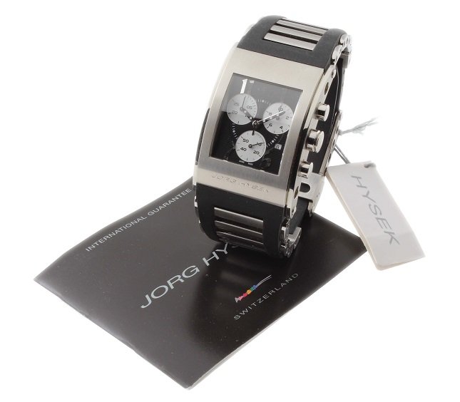 Large Stainless Steel Men`s Jorg Hysek Kilada Watch: Stainless steel gentleman`s Jorg Hysek Kilada with date wristwatch. Black textured Jorg Hysek dial with silver applied Arabic hour markers. The curved shaped case is fitted to a black rubber and stain