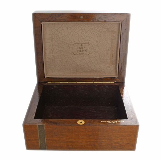 Vintage Patek Philippe Wooden Watch Box: Vintage Patek Philippe wood wristwatch box without inner cushion or cuff. The leather on the underside of the top is crackled. The outside of the box has some scuffs and minor damages. Overall conditi