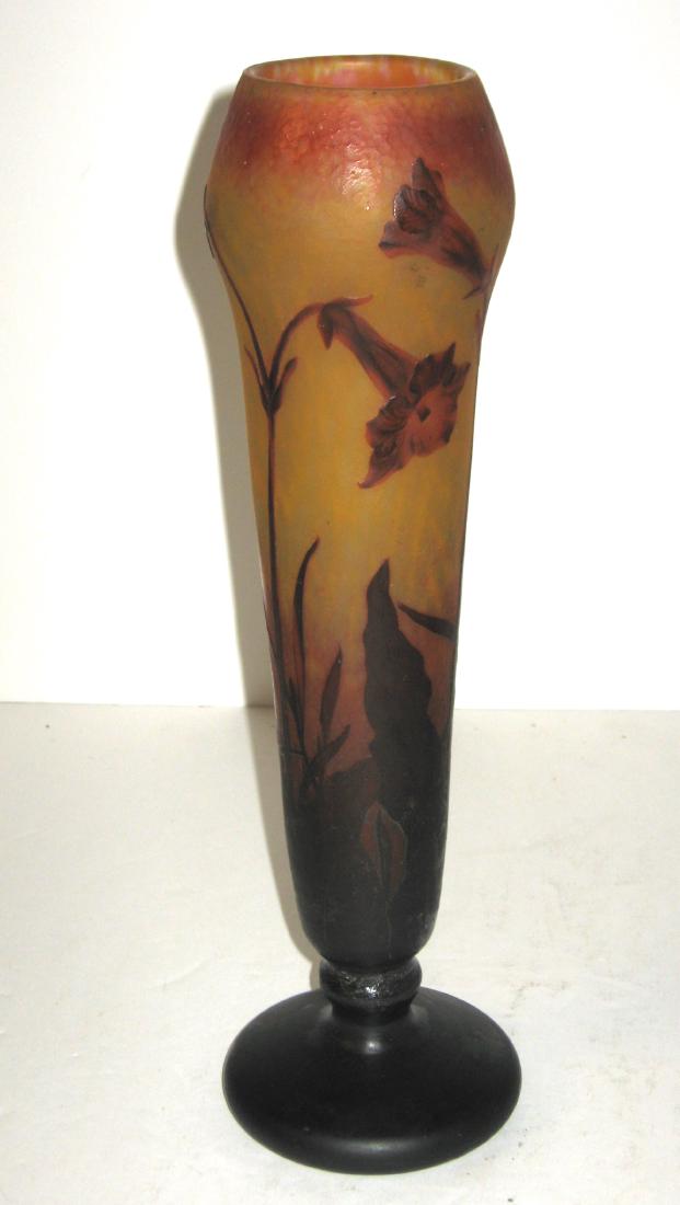 Daum Nancy French cameo glass vase,: Footed cylindrical form in mottled orange and yellow decorated with crimson tobacco flowers, engraved Daum Nancy, 13 3/4" ht. Condition: professional repair to the stem