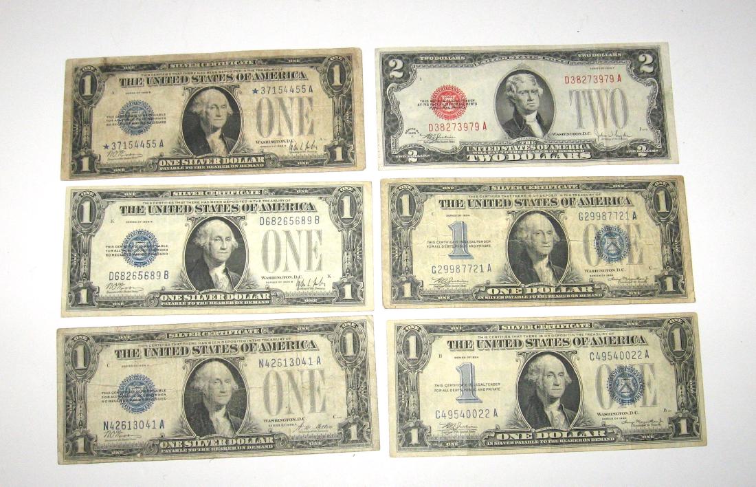 Group of old US currency: Including a 1928 series F 2$ red seal, three blue seal 1928 one dollar bills and two 1934 "funny back" one dollar bills. Condition: good to excellent