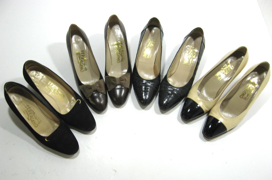 Four pair of Salvatore Ferragamo leather shoes,: Including pair of black brushed, a pair of tan with black toes, a pair of brown with bows, and a pair of black reptile, all marked Ferragamo. Condition: good used condition with no rips tears or cuts.