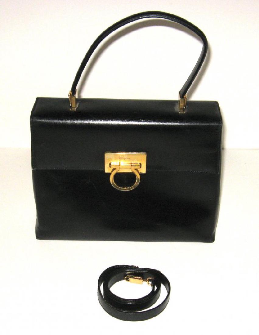 Black Ferragamo leather handbag,: Black leather bag with gold tone hardware marked Ferragamo, 10" by 8" ht. Condition: good with some scuff marks.