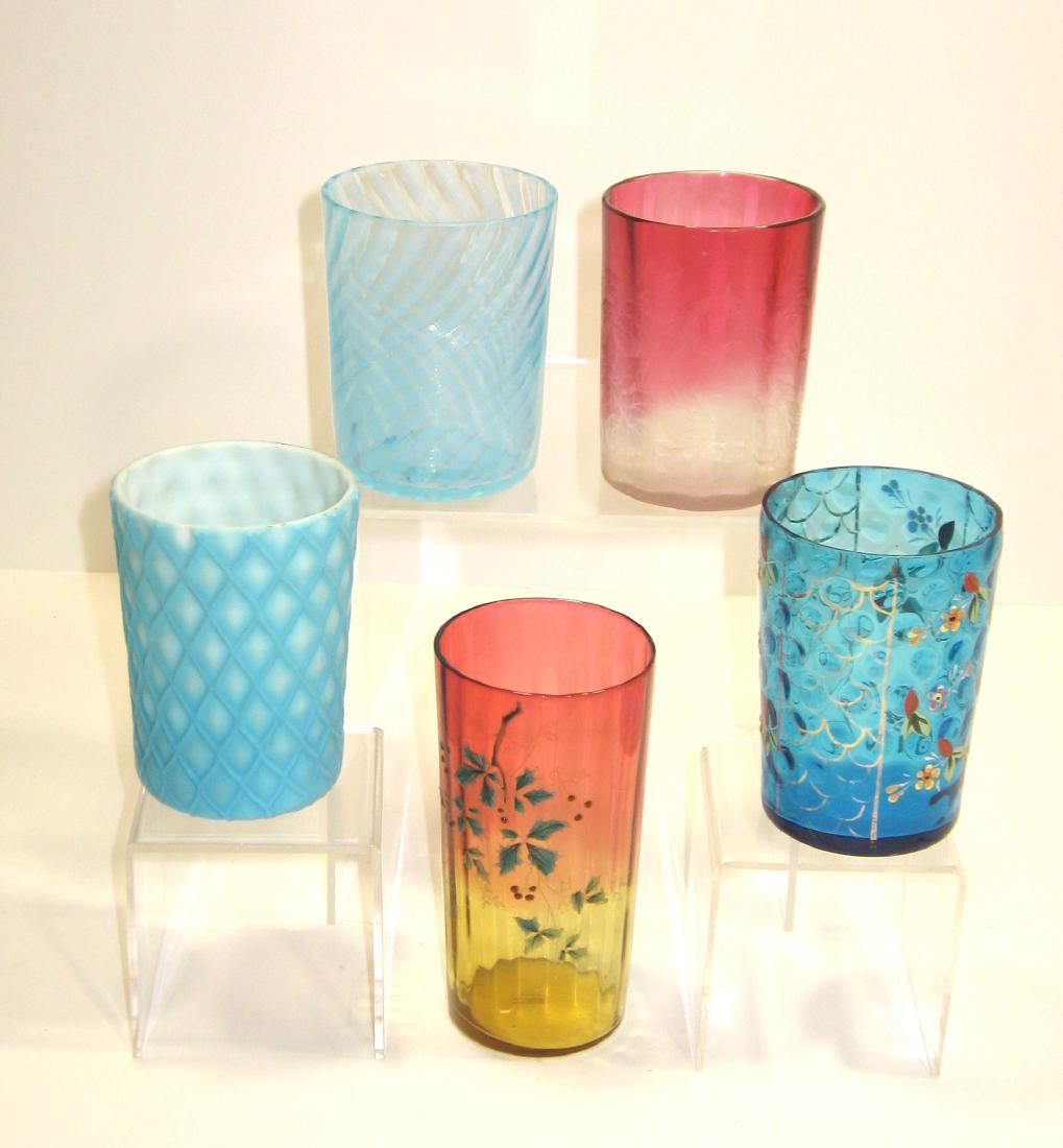 Group of Victorian glass tumblers,: Including a Rubina Verde with holey, a Rubina with etched bird, a blue swirl, blue coin spot with enameled flowers and a blue cut Velvet, tallest 5 1/4" ht. Condition: all good except for a chip to cu