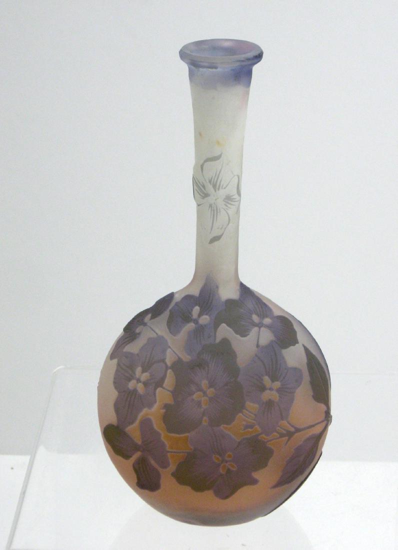 Galle French cameo banjo vase,: Bulbous stick form in pink to frosted glass decorated with a garden of purple flowers with green highlights, signed in cameo Galle 6 1/2' ht. Condition: good with no defects found.