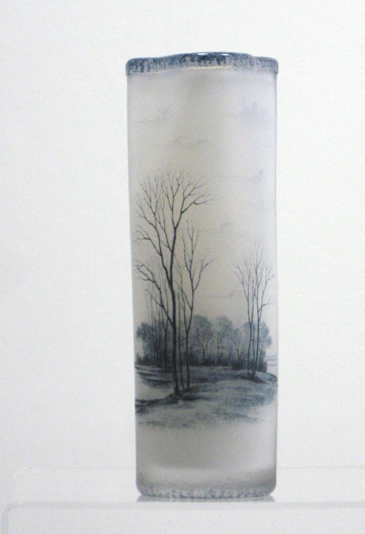 Daum Nancy French cameo glass vase,: Cylindrical form in textured white glass decorated with a lake scene of forested islands, birds and tall grey trees, signed in gold Daum Nancy, 6" ht. Condition: good with no issues.