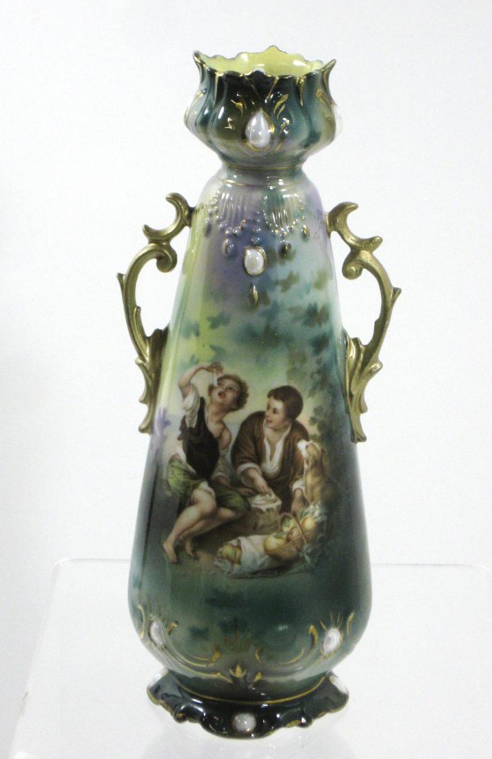 R. S. Prussian two handle vase,: Two handled urn form in green porcelain decorated with the famous scene of Melon eaters, adorned with white jewels, marked with the red and green wreath mark, 8" ht. Condition: good with no defects fo