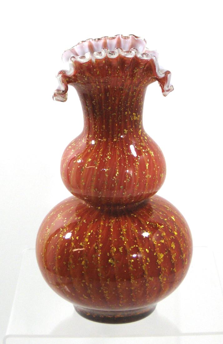 Stevens and Williams glass vase,: Double bulbous form with a scalloped fold over rim decorated with striated yellow and red MOP with overall gold mica, 10" ht. Condition: chip to inside ruffle, see picture.