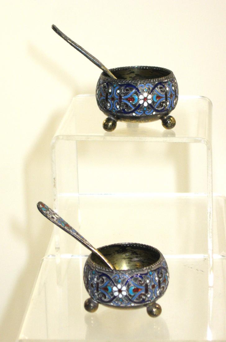 Two Gustav Klingert Russian salts,: Three balled footed salts with enameled scrolling together with matching spoons, all items marked GK, 1 1/2" wide. Condition: good with no issues.