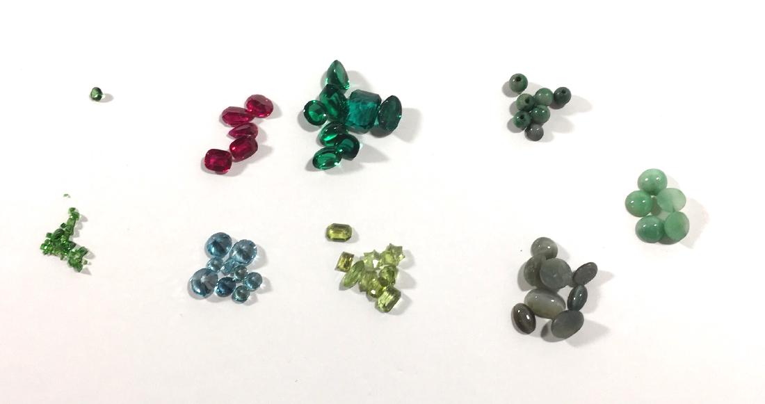 Group of loose stones: Including reconstructed rubies, cubics, Jade, Peridots, Olivines, Cat Eye Quartz and more.