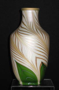 Steuben green Aurene glass vase: Shouldered from in alabaster decorated with a green pulled feather graduating to a gold signed Aurene 597, 9" ht. Condition: good with no defects found.